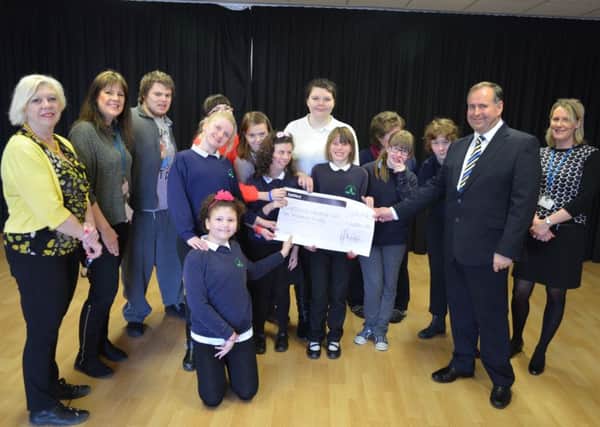 Peter Webb, managing director at Electronic Temperature Instruments, presents the Â£2,000 cheque to the Worthing and Adur Fund at Oak Grove College