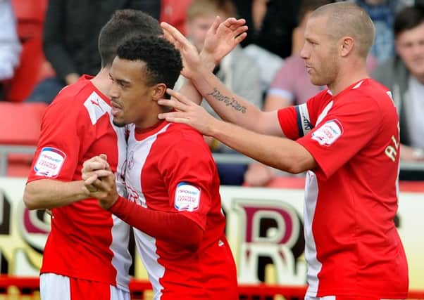 Nicky Ajose celebrating with Gary Alexander and Michael Jones after scoring the winner for Crawley against Leyton Orient. ENGSUS00220120309105530