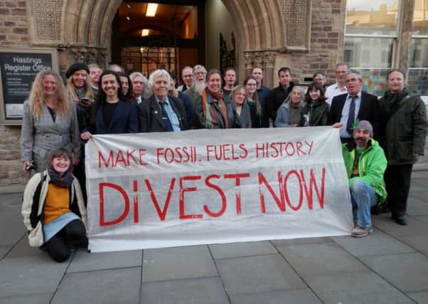 Campaigners celebrated outside the town hall after the council agreed to divest in fossil fuels over the next five years. Photo courtesy of Fossil Free Hastings