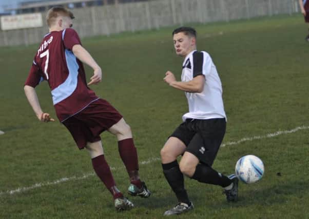 Liam Foster goes in for a tackle during Little Common's 1-0 defeat against Lancing on Tuesday night. Picture by Simon Newstead (SUS-160413-001535002)