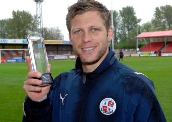 Crawley Town's Dannie Bulman is presented with the Crawley Observer Player of the Season Award by Head of Sport Allan Norbury (Pic by Jon Rigby) ENGSUS00220120305153046