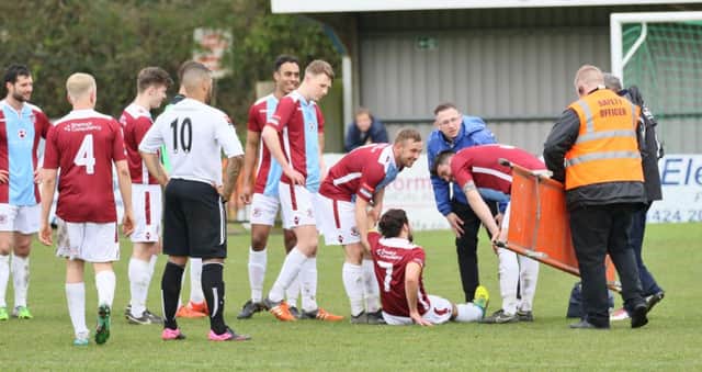 Concern is shown for the injured Billy Medlock during Hastings United's 4-2 win at home to Molesey last weekend. Picture courtesy Joe Knight
