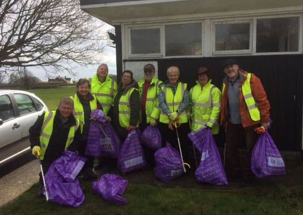 Icklesham Parish Councillors braved the rain to litter pick for the Queen's 90th birthday