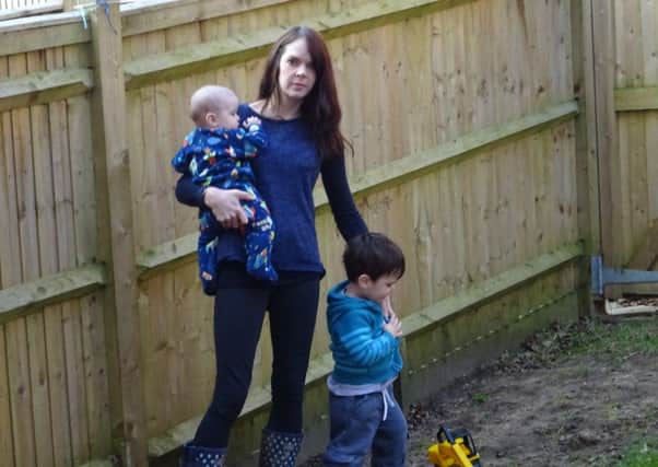 Anna Beck and two of her children in her back garden which they refer to as 'The Mud'