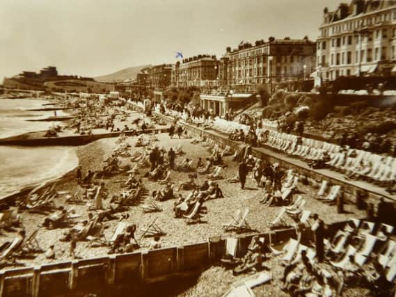 Hundreds of people enjoying the sunshine on the beach in the 1950s