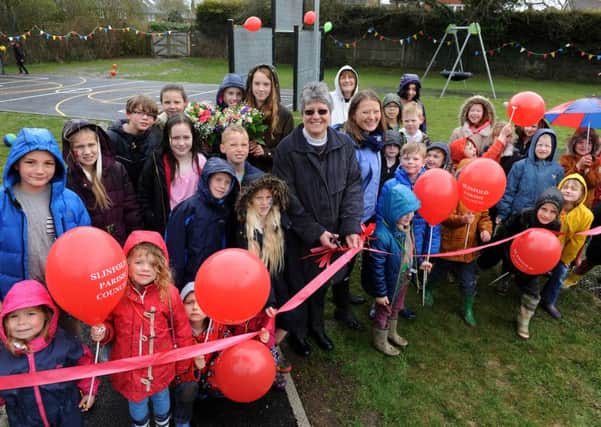 Slinfold Parish Council spend Â£30,000 on rejuvenating play field at Grattons, Slinfold. Rev, Sandra Hall and Miss Laura Phibbs (Headteacher Slinfold C of E Primary) cut the ribbon to unveil the new facilities. Pic Steve Robards SR1610611 SUS-160418-130213001