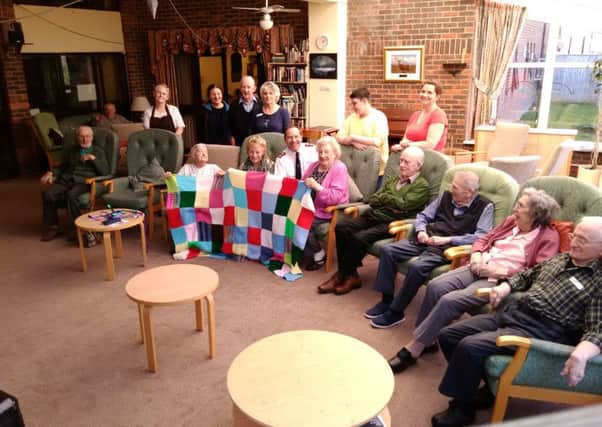 Major Iain Stewart of Horsham Salvation Army with all the knitters at Dingemans