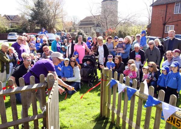 DM16111971a Manager Tracy Vise cuts the ribbon to open the garden at Church Lane Nursery in Southwick