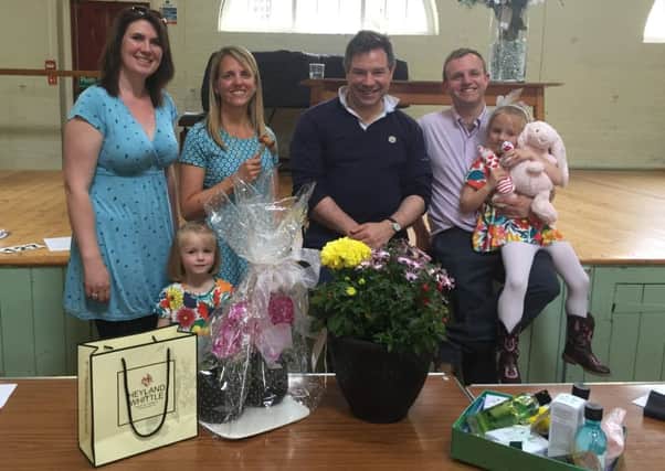 A charity auction raised Â£1,300 for St Catherine's Hospice. Pictured (L-R) are Anna-thea got in the mood bidding on a pink rabbit, which she duly won. Shes pictured far right with auction volunteer Sarah Shelton, organiser Laura Sykes, her daughter Jemima, Horsham MP, Jeremy Quin and husband Andy - picture submitted by Jeremy Quin