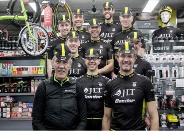 Stephen Crossley, centre, with some of the team, including organiser Alastair Robertson, front right, and former English rugby union player, Roger Uttley, kit fitting at Condor Cycles, London
