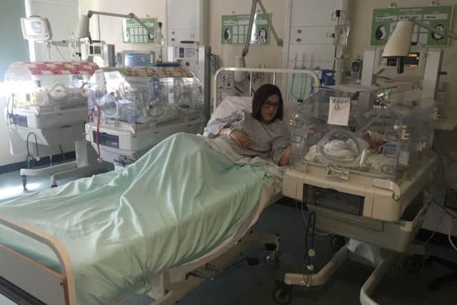Rachel Ballard in between her three new babies at St Richard's Hospital