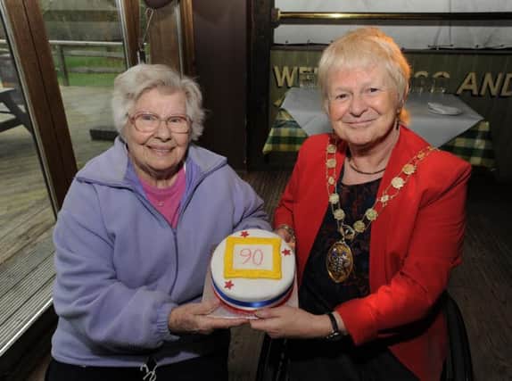 Margaret Oyler from Crawley is presented with a birthday cake by Cllr Chris Cheshire SUS-160422-145817001