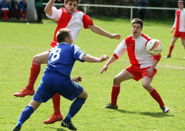 Action from Midhurst (in blue) v Selsey / Picture by Derek Martin