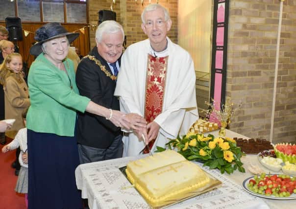 Father Chris Ingle and Worthing mayor and mayoress Michael Donin and Linda Williams cut the Bible-shaped cake made by Mrs Moira Clark