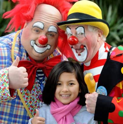 Alyssa Lock, age 9,, with two of the 30 clowns coming. Pic Steve Robards  SR1612017 SUS-160427-130037001