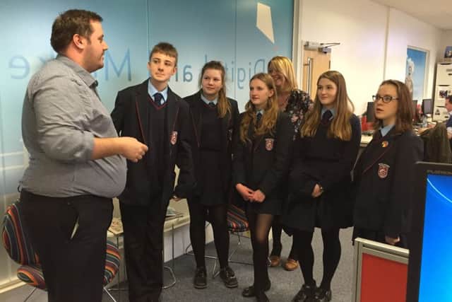 The students talking to one of Hastings Direct's marketing team