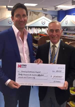 Ed Giddens presenting Peter with the cheque for the proceeds of the auction held at the ball SUS-160305-114939001