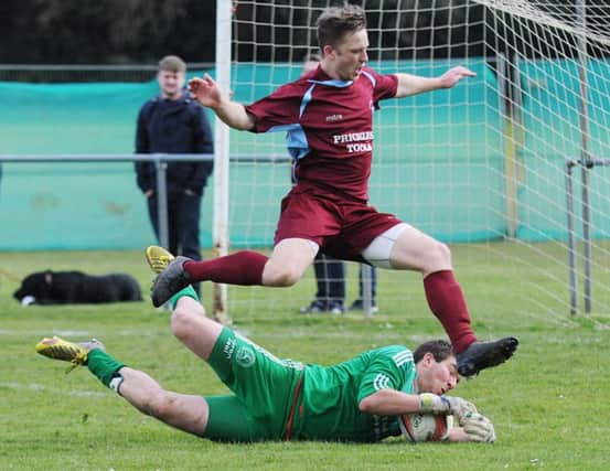 Midhurst goalkeeper Aaron Jeal denies Little Common striker Jamie Crone. Picture courtesy Jon Smalldon