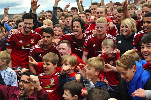 Worthing's players and fans celebrate promotion