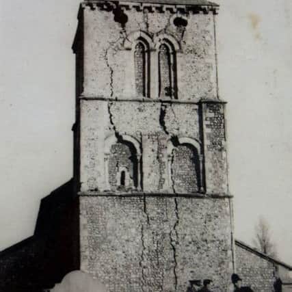 The tower of St Michael and All Angels  Church in 1941, showing cracks caused by the German bomb and the bomb disposal officer talking to a policeman