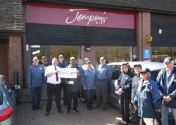 Dominic Plomer-Roberts from Jempson's presenting the cheque to the Rye and District Street Pastors