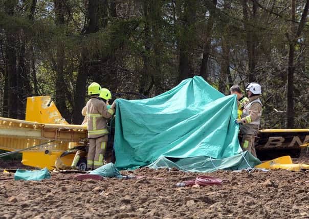 Firefighters at the scene of the crash on Saturday (April 30). SWNS SUS-160305-114919001