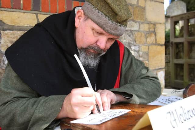 DM16114051a.jpg Medieval Midhurst tourist event. Paul Ulson doing medieval style handwriting. Photo by Derek Martin SUS-160430-214344008