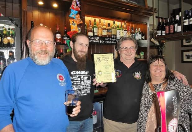 Branch co-ordinator Steve Pardoe (left) presented the winner's certificate to licensees Andy and Linda Brooks, who are seen with son Henry, one of the pub's chefs. Photo by Ian MacDonald. SUS-160305-144031001