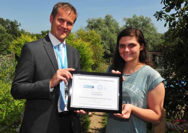 Vanessas daughter, Nicole, receiving the Outstanding Young Person of the Month award in July 2014. Picture by Steve Hunnisett