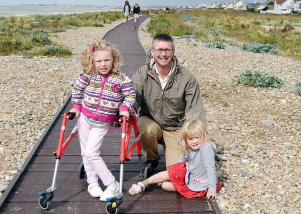 Ben Stride, who is undertaking the bike ride, with his daughters Darcey and Neeley. Photo by Liz Pearce. SUS-150728-184455008