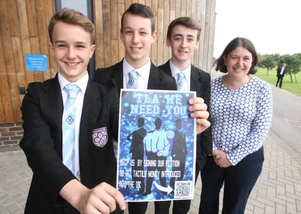 Students start campaign to get tactile money introduced. The students, L to R Louis Bailey, Vinnie Denton and Cullen Wright-Lowdell all age 15 and teacher Rosalind Waite-Jones. Photo by Derek Martin SUS-160905-175803008