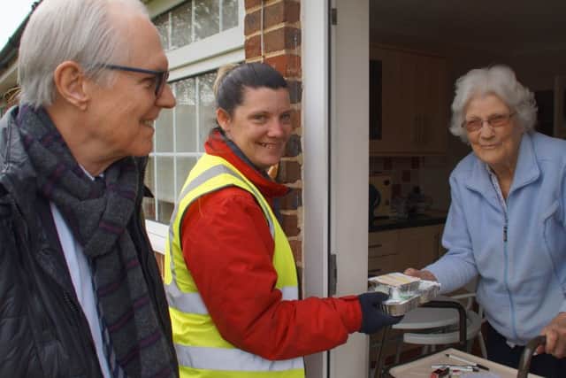 Peter Catchpole, West Sussex County Council cabinet member with Apetito delivery driver Caz Huchison meets resident Lorna Townsend (photo submitted). SUS-160505-151749001