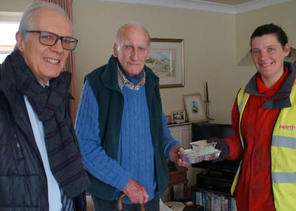 Peter Catchpole, West Sussex County Council cabinet member with Apetito delivery driver Caz Huchison meets resident Major Piers de Berniers-Smart (photo submitted). SUS-160505-151800001