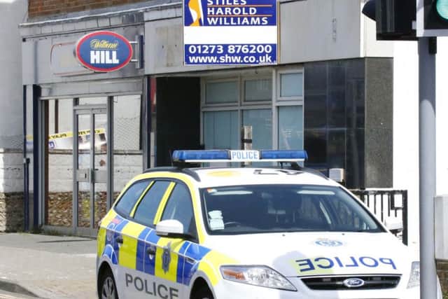 A police car outside William Hill in Lancing. Photo by Eddie Mitchell.