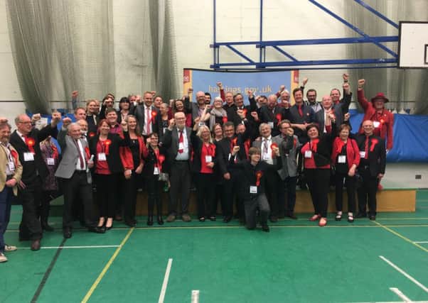 Labour councillors, candidates and supporters celebrate holding its control of the council SUS-160605-033653001