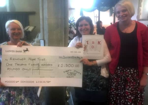 Alice Banks, project co-ordinator at the Renewed Hope Trust (left) and administrator Ann Smith (right) recieve a Â£1,300 cheque at St Bartholomew's Church in Horley from night shelter co-ordinator Anna Coe (centre). The money was donated by the horley community and members of St Bart's, St Wilfrid's and St Francis Churches - picture submitted