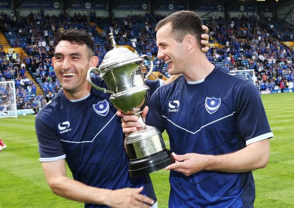 Gary Roberts, left, congratulates Michael Doyle on his The News & Sports Mail player of the year trophy. Picture: Joe Pepler