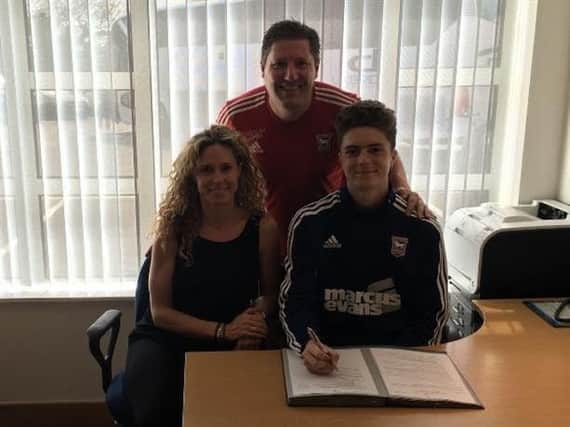 Patrick Webber puts pen to paper on his scholarship deal with Ipswich. Picture by Ipswich Town Football Club