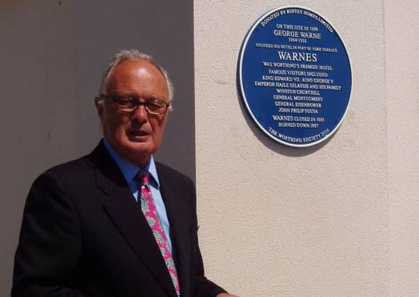 David Sumner next to a blue plaque in 2006.