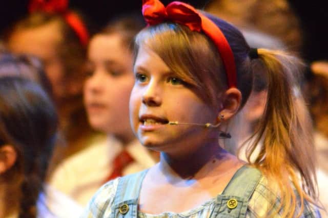 Pupils at Summerlea Community Primary Schools Glee Club took over The Windmill Theatre. Ellie Bennett, from year five, performs.