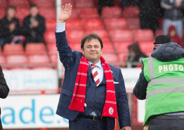 New owner Ziya Eren waves to Crawley Town fans before their game against Oxford United, 9th April 2016. (c) Jack Beard SUS-160904-223859008
