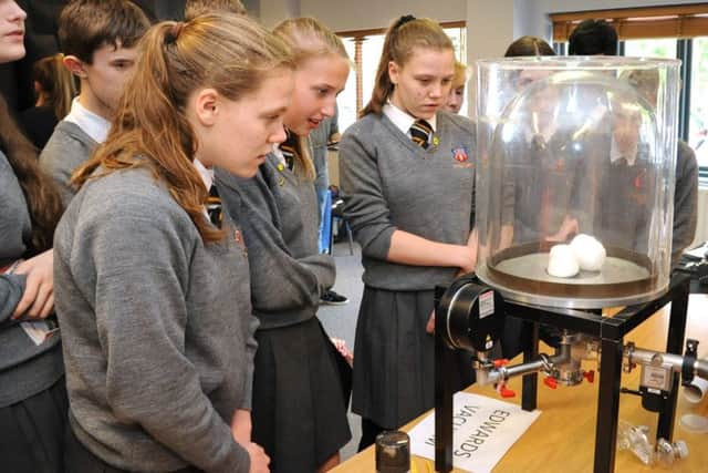Students watch as marshmallows expand in a vacuum. Photo courtesy of STEM Sussex