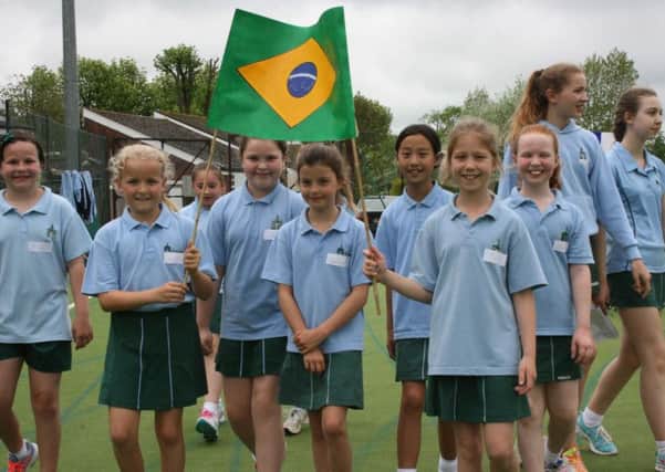 Farlington girls carrying the flags at their sports festival