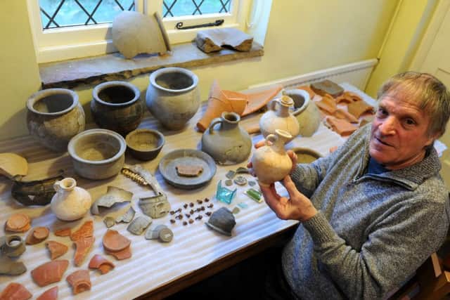 Jon Cann with some of the Roman pottery found near his house.Picture by Kate Shemilt.C141496-1
