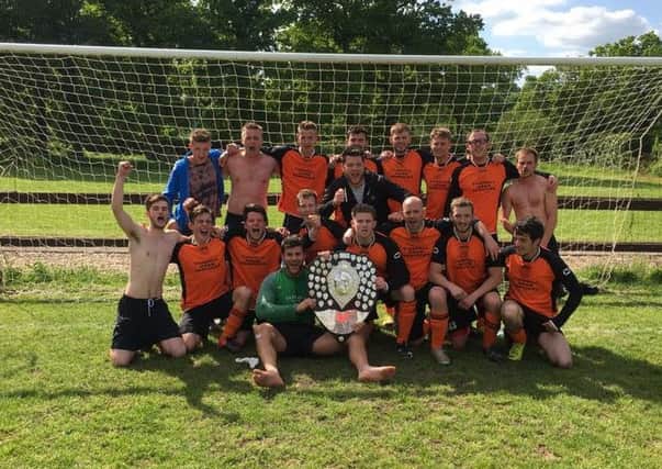 Ewhurst Reserves celebrate with the West Sussex Football League Division 5 North trophy