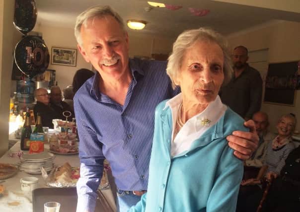 May Guinness cuts her 100th bithday cake with her son, Keith