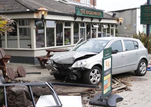 A car has gone into the Pizzarelli takeaway. Photo by Eddie Mitchell.