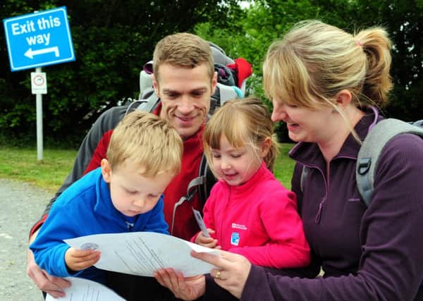 Picture: Kate Shemilt. Walkers David and Clare Ayling and their children Grace, four and Thomas, two looking at the route. ks16000653-3