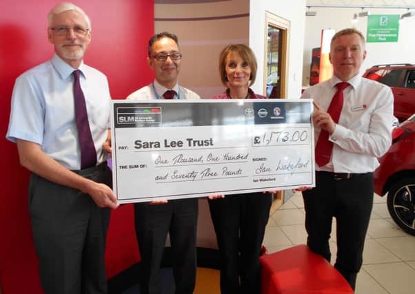 Sara Lee Trust CEO Dan Redsull receiving a cheque for ?1,173 from  Ray Billenness, Mel Ball,  and Gus Wakeford of St Leonards Motors Group SUS-160531-130716001