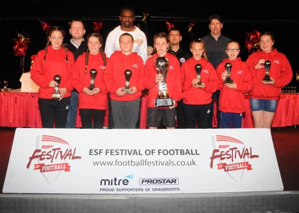 Crawley Town girls U11s presented with the ESF Festival champions trophy by former Tottenham and England player Darrren Anderton SUS-160517-093838002
